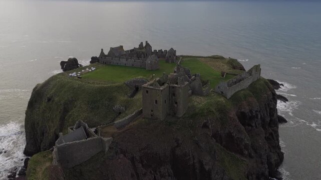 Stunning aerial footage of the historic dunnottar castle, a ruined medieval fortress located on a rocky headland on the northeastern coast of scotland