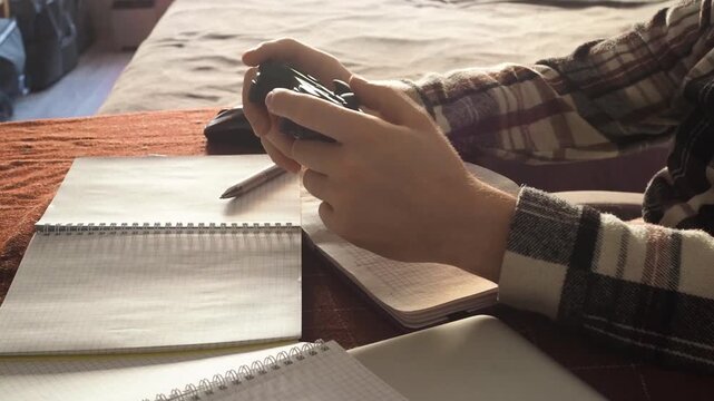 Young man playing video game at home. Nervous guy holding play station in hand. 