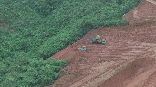 The process of unloading soil in road construction, a truck is loading soil into the truck bed
