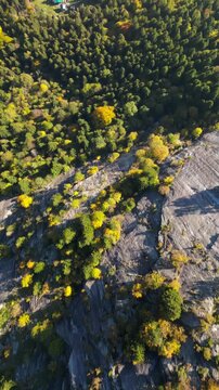 Aerial view of Val di Mello featuring steep granite cliffs and colorful autumn foliage in Val Masino, Lombardia, Italy.