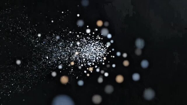 Abstract image of glowing particles and bokeh lights against a dark background, creating a dynamic and ethereal effect.