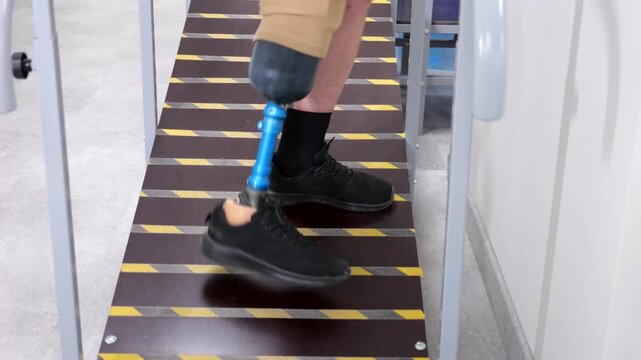 Amputee with prosthetic leg walking uphill for rehabilitation