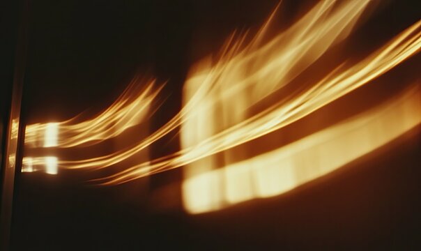 Golden light streaks across a dark wall with window reflections creating abstract motion