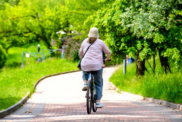 Fototapeta premium Cyclist ride on the bike path in the city Park 