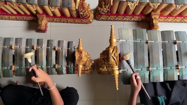 High angle view of musicians playing Gender Wayang, a traditional Balinese gamelan instrument in Bali, Indonesia