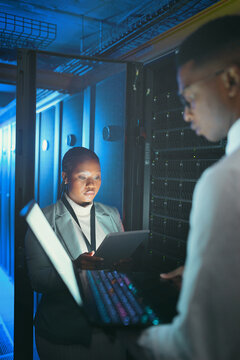 Tech, people and inspection in server room for database, system performance or update in dark. Laptop, tablet and technician in data center for network diagnostics, machine learning or IT maintenance