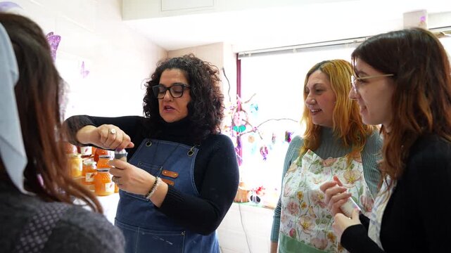 Group of women enjoying and learning about fragrances during a candle making class