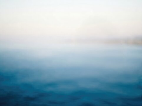 A soft, blurred image depicting a gradient of cool blue tones, evoking a sense of tranquility and depth.