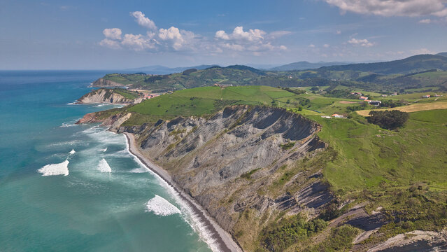 Rocky coastline and green cliffs aerial landscape