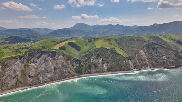 Rocky coastline and green cliffs aerial landscape. Flysch Begiratokia - Baratzazarrak. Deva, Gipuzkoa, Spain.