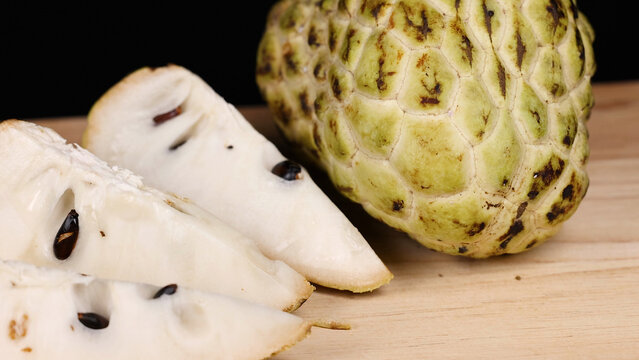 Close Up of Sliced Custard Apple on a Wooden Surface
