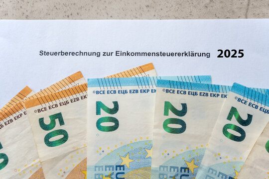 Tax return paper 2025 and much paper money bills.