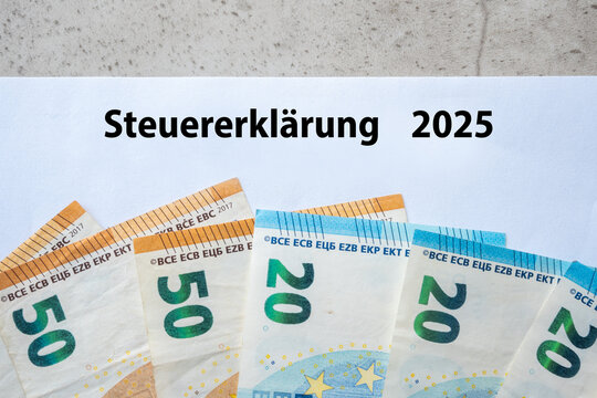 Tax return paper einkommenateuererklarung 2025 and much paper euro money bills.