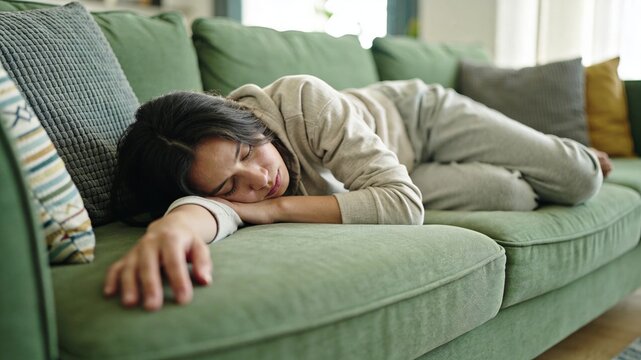 Tired woman lying on a green couch