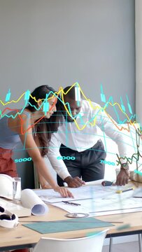 Vertical video: Woman pointing plan, man measuring plan in design aligning sizes under AR charts