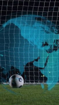 Vertical video: Striker kicking ball to score in sports goal keeper diving dotted globe overlaying