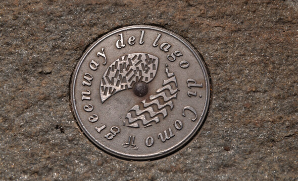 close up of Lake Como metal trail marker in pavement