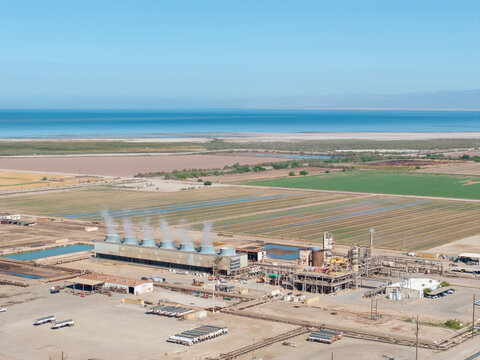 High perspective of industrial cooling towers at an energy site
