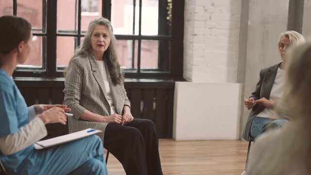 Women group therapy, senior ladies listening to physician talking about aging. Psychological consultation in modern clinic, elderly woman talking with professional gynecologist or endocrinologist