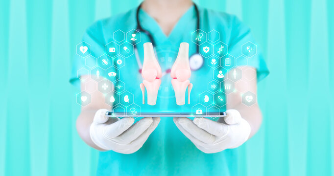 Concept of telemedicine and digital orthopedic monitoring, early detection of avascular necrosis of the knee. Patient health and medical technology. A doctor examines the bone structure on a tablet.