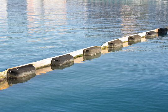 Floating anti-pollution barrier made with modular plastic elements to protect from water pollution - Environmental protection concept
