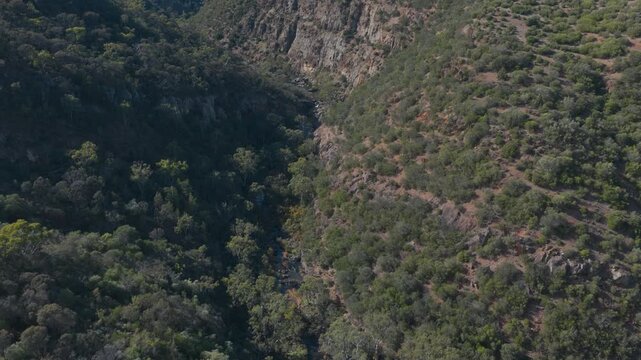 Aerial view of Onkaparinga Gorge featuring steep rocky cliffs, dense native bushland, and a deep valley under bright daylight Blewitt Springs, South Australia, Australia.