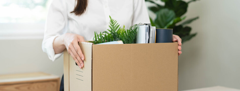 unemployed concept, employee clear her stuff at office to move out after get layoff from company in recession.