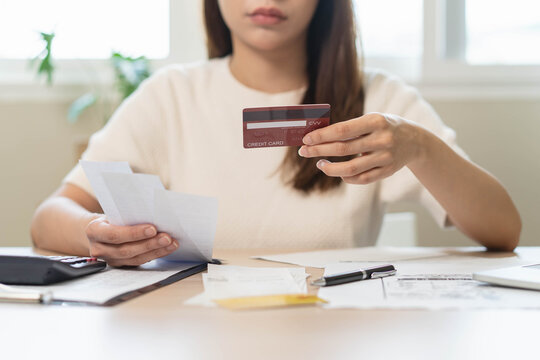 person using calculator calculating tax refund on the table