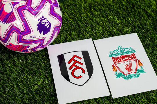 Fulham vs. Liverpool Premier League match, official soccer ball on green grass, wallpaper with edit space.
