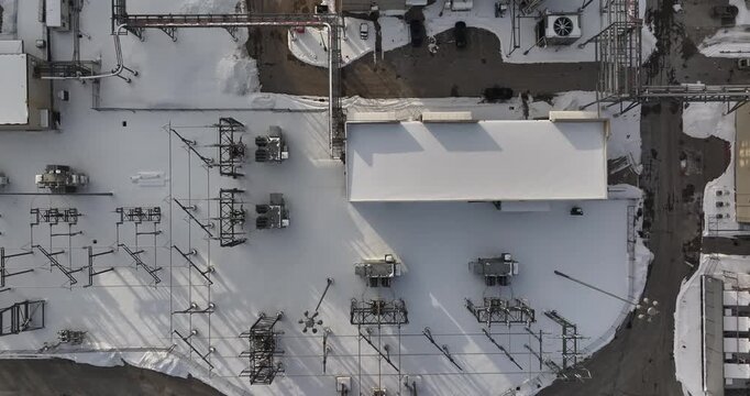 Aerial view of an electrical substation with snow-covered transformers and power lines in Reading, Ohio, United States.