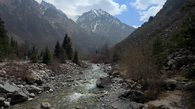 Mountain river in Ala-Archa gorge with mountain background spring landscape Kyrgyzstan

