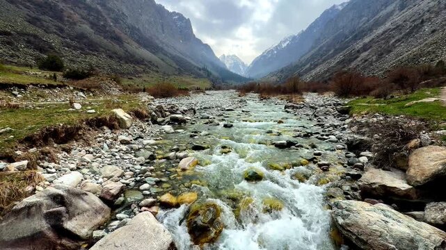 Mountain river in Ala-Archa gorge with mountain background spring landscape Kyrgyzstan

