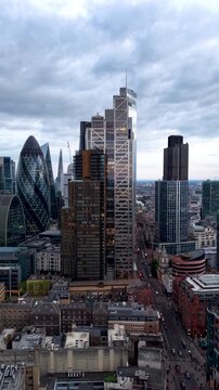 Panoramic aerial view of the illuminated City of London skyline with office skyscrapers and street traffic at Bishopsgate and Liverpool Street