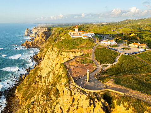 Cabo da Roca Lighthouse and Cross. Cape Roca, Cliffs and Atlantic Ocean at Sunset. Portugal. Aerial View