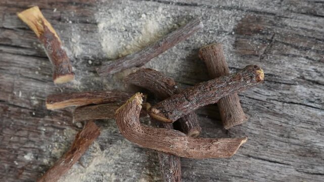 ayurvedic mulethi or liquorice root stick or jeshthamadh powder on wooden background