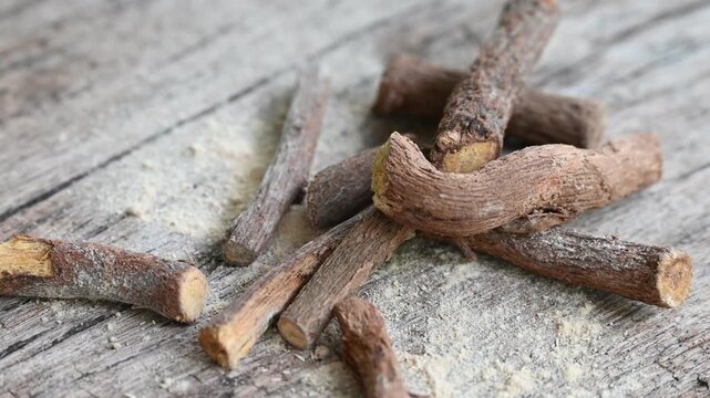ayurvedic mulethi or liquorice root stick or jeshthamadh powder on wooden background