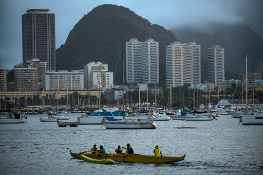 Outrigger Canoe Paddling through Guanabara Bay with Botafogo Skyline in Rio de Janeiro, Brazil