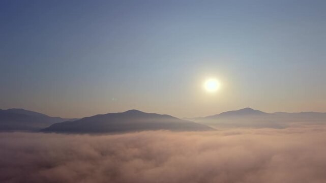 High-quality 4K aerial skyscape featuring a majestic sunset, dramatic storm clouds, and sun rays over mountain silhouettes. Perfect for VFX, cinematic plates, and atmospheric transitions.