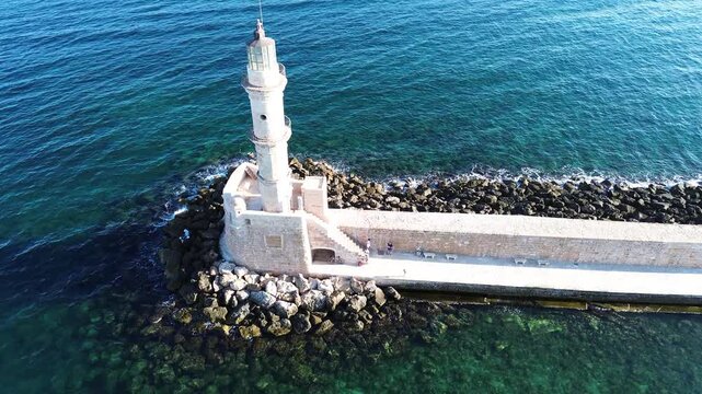 bay of Chania with sea and lighthouse at sunny summer sunset, Crete, Greece,