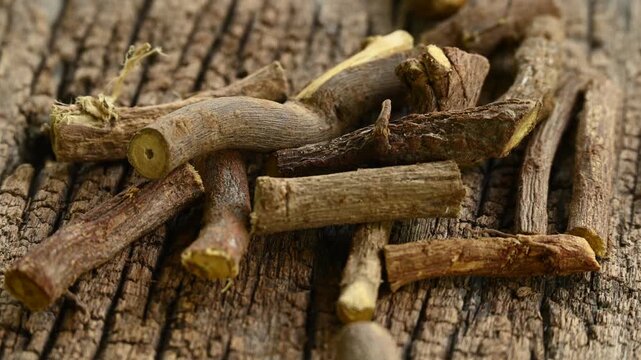 ayurvedic mulethi or liquorice root stick or jeshthamadh powder on wooden background