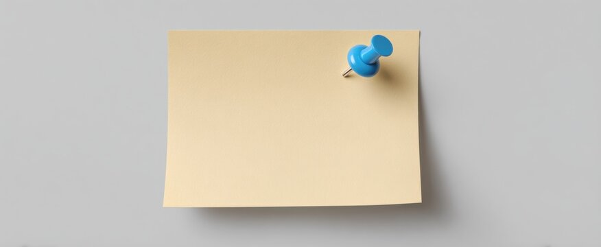 Soft beige memo paper with a blue push pin and crisp folded corner on light gray backdrop
