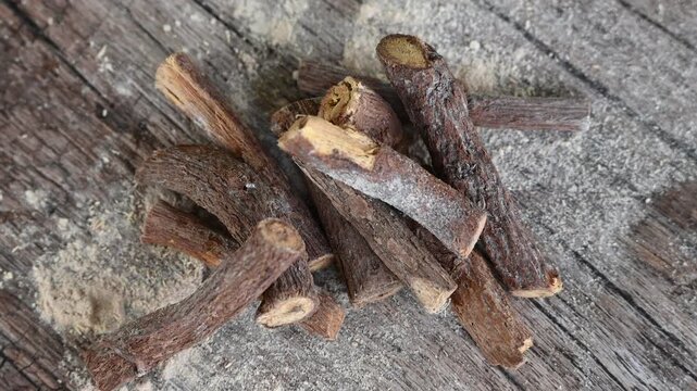ayurvedic mulethi or liquorice root stick or jeshthamadh powder on wooden background