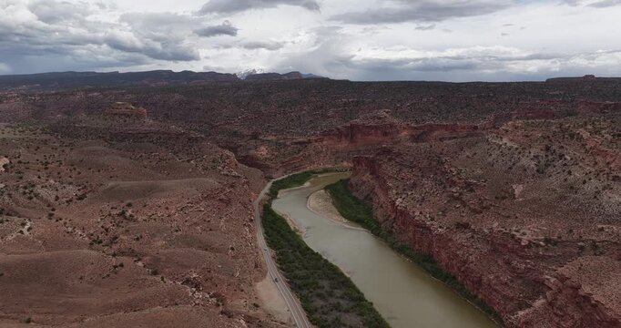 Aerial of Colorado River in Dewey Utah with La Sal mountain view in spring with dramatic stormy sky