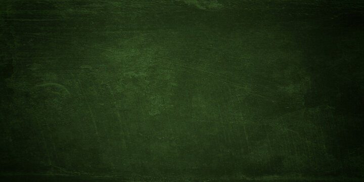 An aged and empty green chalkboard with a rough grunge texture provides a dark vintage surface for a blank backdrop or wallpaper pattern