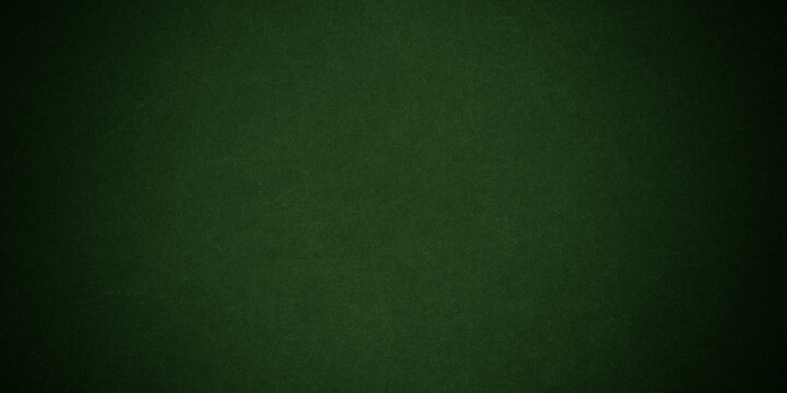 An aged and empty green chalkboard with a rough grunge texture provides a dark vintage surface for a blank backdrop or wallpaper pattern
