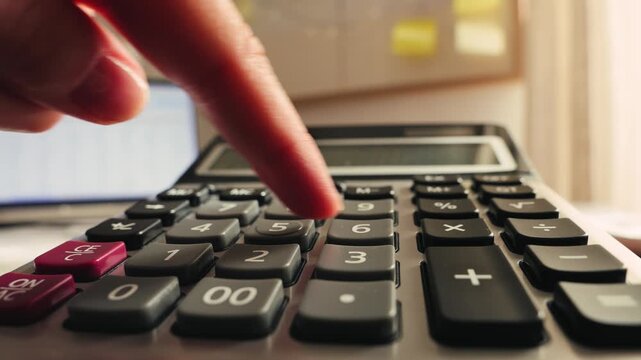 Hand presses buttons on calculator, counting expenses, calculating a budget. High quality 4k footage