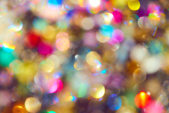 Vibrant multi-colored bokeh background with soft out of focus light circles. Festive abstract texture for holiday design.