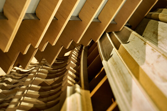 Abstract architectural detail of wooden geometric structures with repetitive patterns. Modern interior design and woodwork