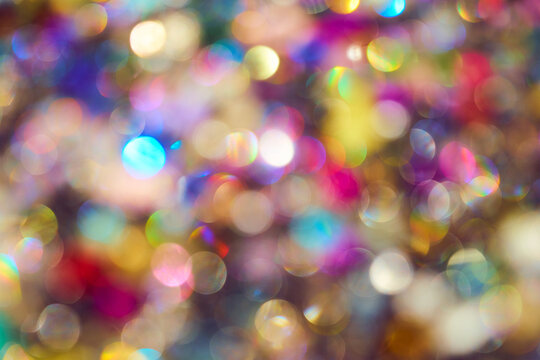 Vibrant multi-colored bokeh background with soft out of focus light circles. Festive abstract texture for holiday design
