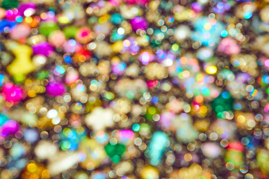 Vibrant multi-colored bokeh background with soft out of focus light circles. Festive abstract texture for holiday design.